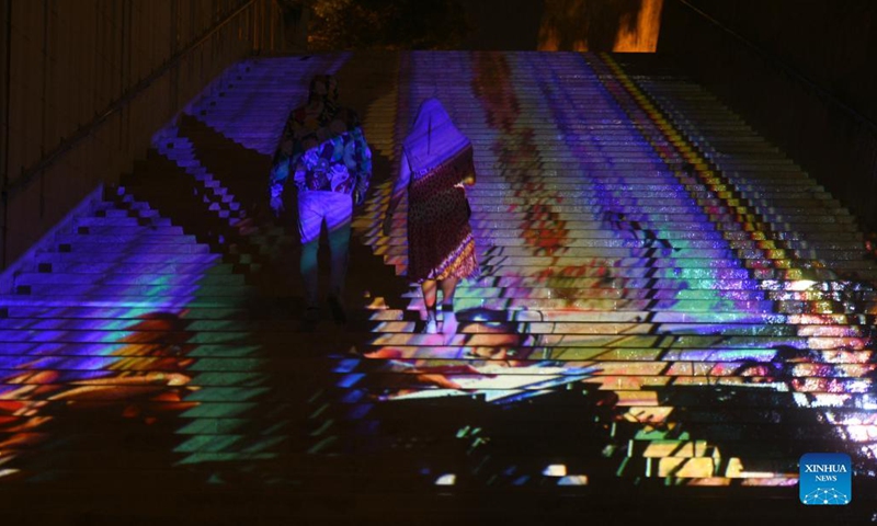 People walk up the light-decorated steps in Valletta, capital of Malta, on Oct. 13, 2021. Pedestrian spaces in Valletta's streets and squares are adorned with illuminations for the initiative Light Up Valletta.(Photo: Xinhua)