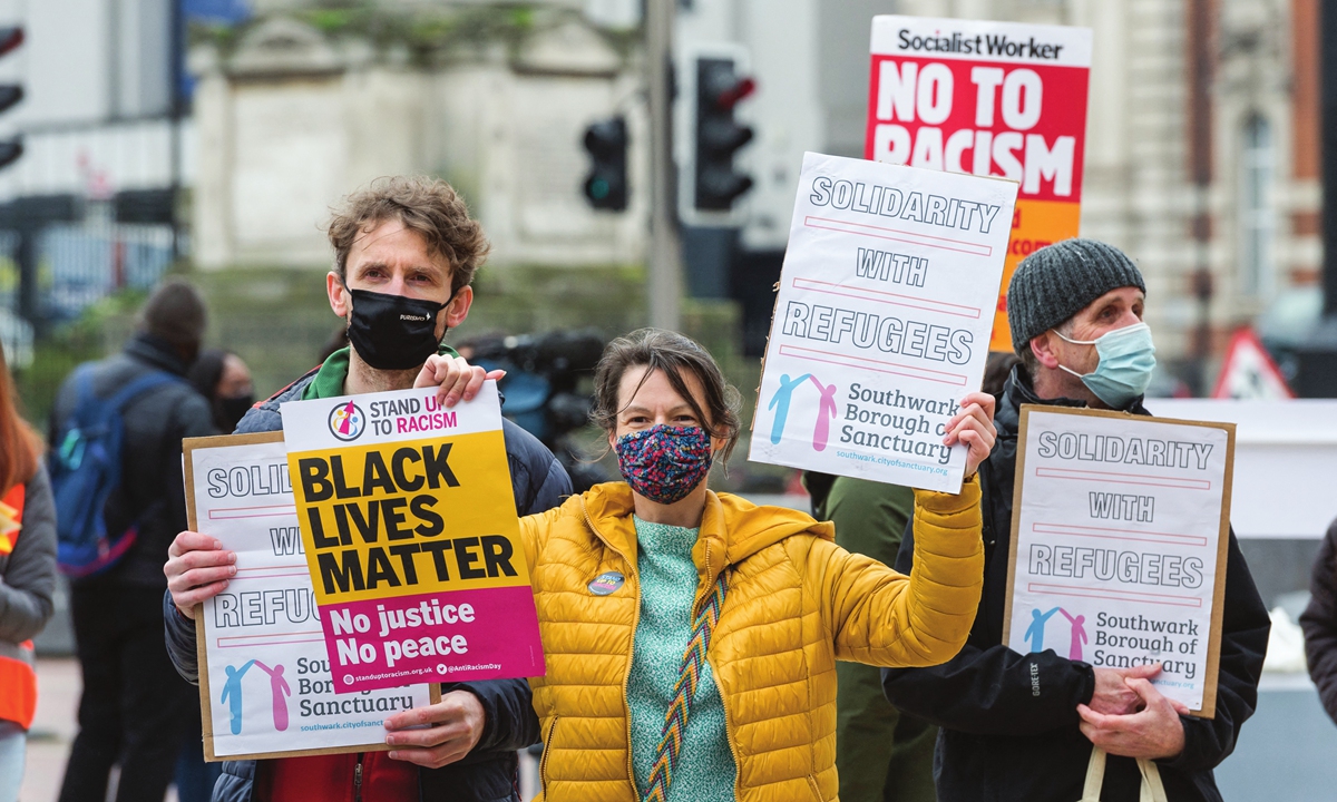 People gather in London to protest against racism to mark the United Nations Anti-Racism Day on March 20 in the UK. Photo:AFP
