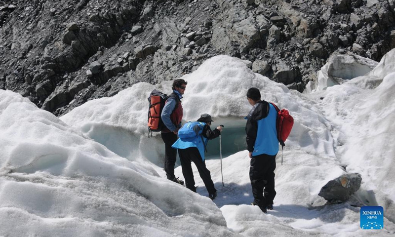 Tourists hike on Fox Glacier on the west coast of New Zealand's South Island on Oct. 13, 2021. Fox Glacier is one of the most accessible glaciers in the world. In the past decades, the glacier retreated significantly due to global climate change. (Photo: Xinhua)