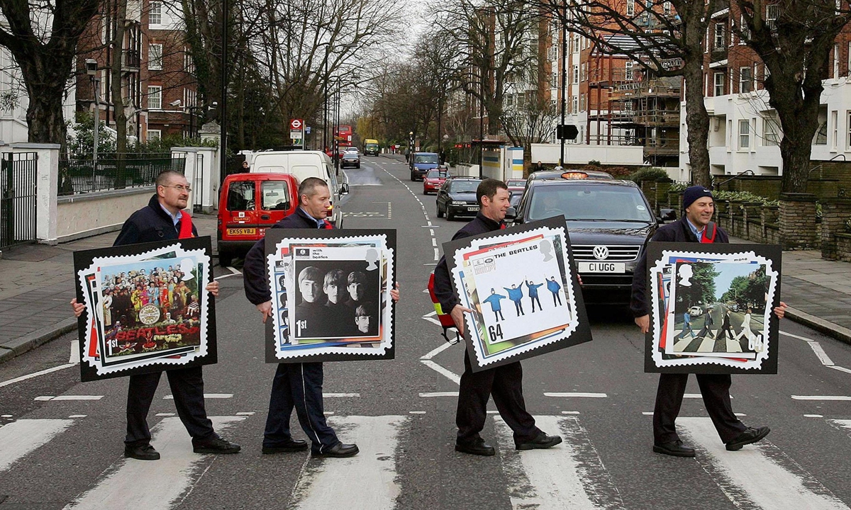 Royal Mail postmen re-created the Beatle's famous <em>Abbey Road</em> album cover to launch Royal Mail's special The Beatles stamps on August 8, 2009. Photo: VCG