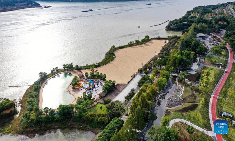 Aerial photo taken on Oct. 13, 2021 shows the view of a waterside park in southwest China's Chongqing. A 33km waterside walkway, which links six areas and eight parks in different themes along two rivers, was built in Yunyang district of Chongqing, providing residents a nice place to spend their leisure time. (Xinhua/Wang Quanchao)

