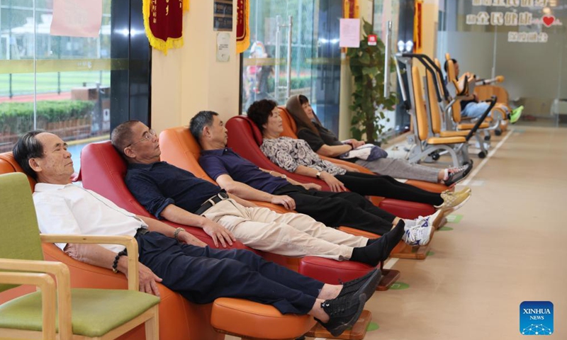 Elders relax on massage sofas at a senior care center in Xuhui District of Shanghai, east China, Oct. 13, 2021.Photo:Xinhua