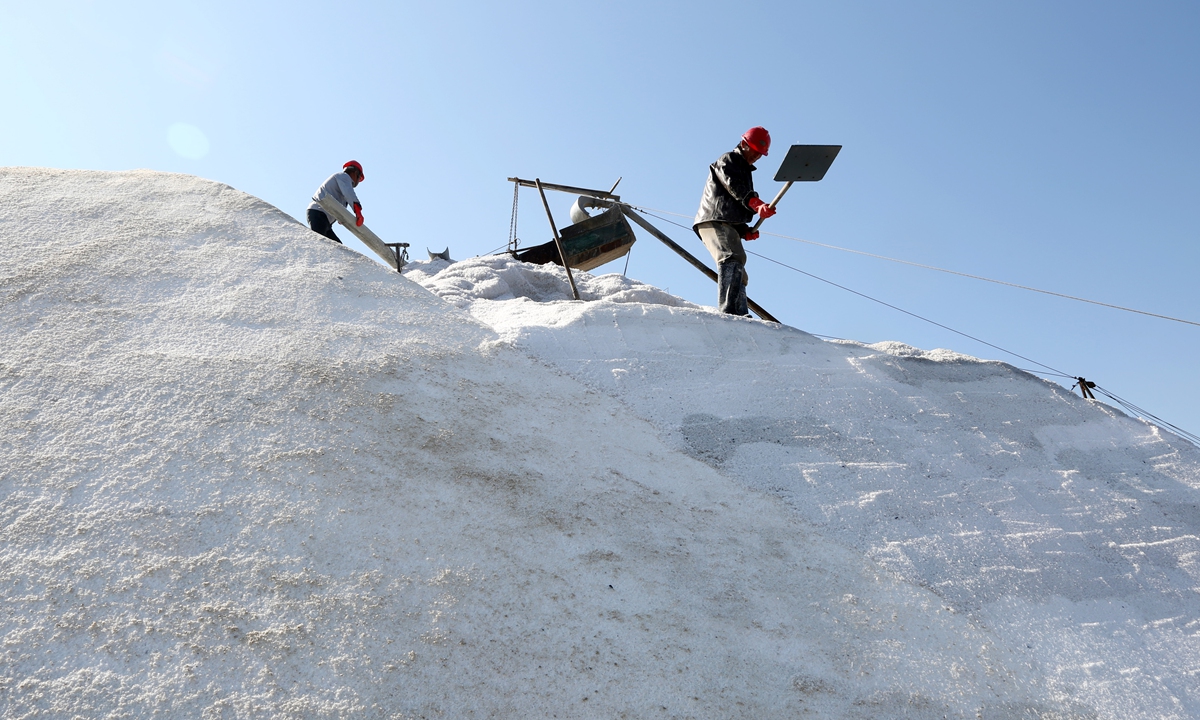 Workers harvest raw salt in Lianyungang, East China's Jiangsu Province on Sunday. During the golden autumn season, more than 10,000 acres (4,047 hectares) of salt fields in the city welcome a bumper harvest, according to media reports. Photo: cnsphoto