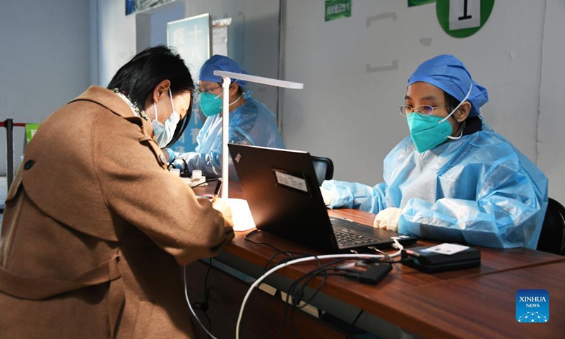 A woman has her information registered before getting a booster shot of the COVID-19 vaccine at a vaccination site in Xicheng District of Beijing, capital of China, Oct. 17, 2021. Beijing has begun to offer a third COVID-19 booster vaccine to people of higher risks in some neighborhoods.Photo: Xinhua