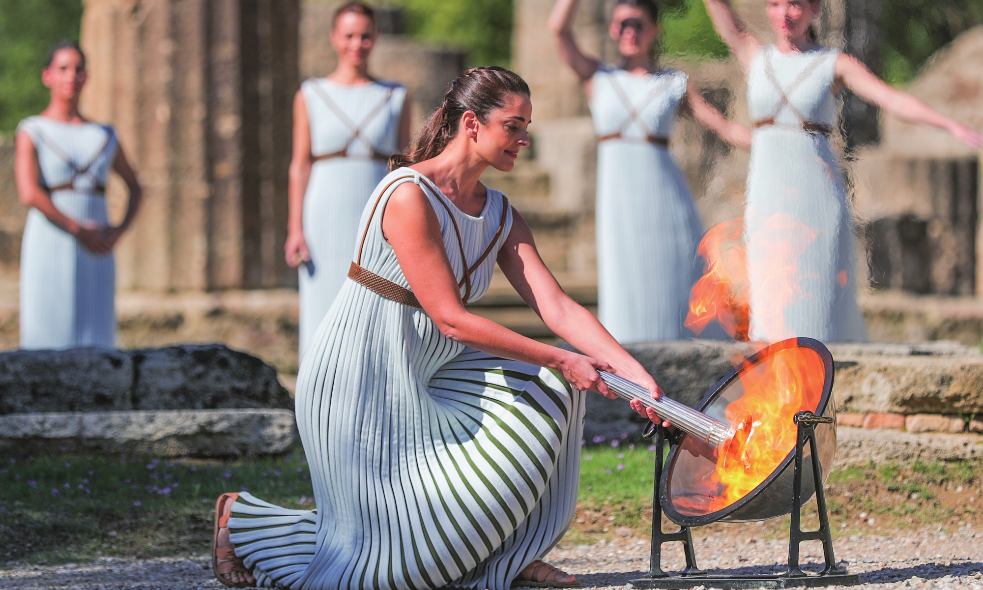 Greek actress Xanthi Georgiou (R, front), playing the role of an ancient Greek High Priestess, lights a cauldron with the Olympic Flame during the Olympic flame lighting ceremony for the Beijing 2022 Winter Olympic Games, in ancient Olympia, Greece, on Monday. Photo: Xinhua