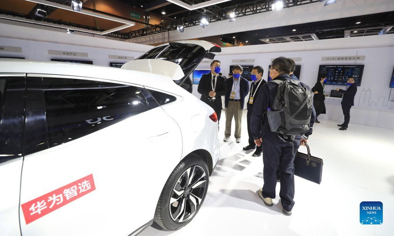 Participants learn about an electric car displayed at the booth of Huawei Technologies Co., Ltd. at an auxiliary exhibition during the 2021 Global Industrial Internet Conference in Shenyang, capital of northeast China's Liaoning Province, Oct. 18, 2021. The 2021 Global Industrial Internet Conference kicked off here on Monday.Photo: Xinhua
