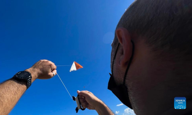 A man flies a kite during the 4th edition of the International Kite and Wind Festival in the village of Gharb on the island of Gozo, Malta, on Oct. 17, 2021.(Photo: Xinhua)