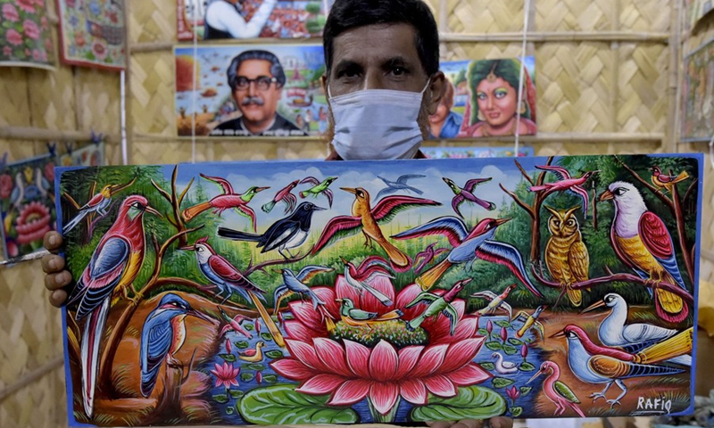 An artist shows a rickshaw paint during an exhibition in Dhaka, Bangladesh on Oct. 17, 2021.(Photo: Xinhua)