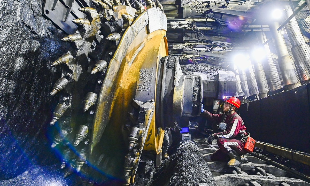 A worker overhauls a mining machine at a coal mine in Ejin Horo Banner, North China's Inner Mongolia Autonomous Region on Tuesday. In response to the coal shortage in China and on the premise of ensuring environmental and production safety, Ejin Horo Banner resumed output at mines that passed safety inspections. Daily output now exceeds 660,000 tons. Photo: VCG 