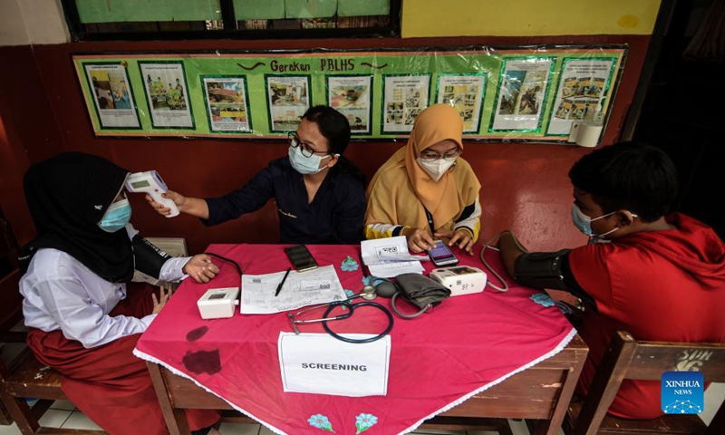 Students have their health condition checked before receiving doses of the COVID-19 vaccines in Tangerang, Indonesia, Oct. 18, 2021. The emergence of COVID-19 cases in schools has prompted an urgent need for COVID-19 vaccination for children. (Photo: Xinhua)