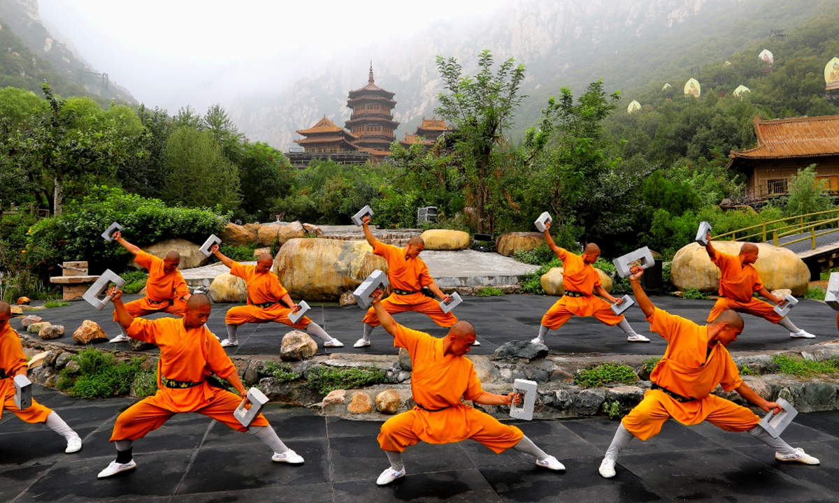 Chinese monks practice martial arts in the Shaolin Temple, Central China's Henan Province in 2019. Left: People take part in the Parade for the Chinese community living in Lisbon, as part of the Chinese New Year celebrations, in Lisbon, Portugal in 2018. Photos : I C