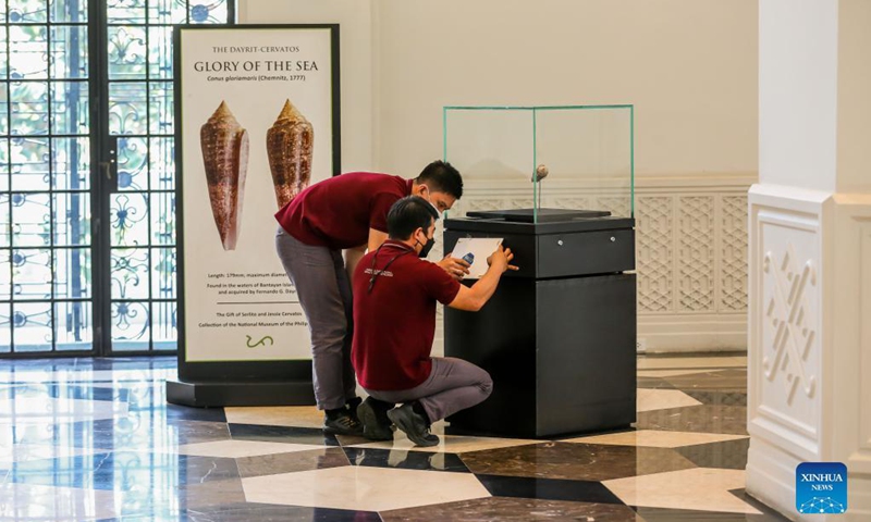 Staff members prepare a display at the Philippine National Museum in Manila, the Philippines on Oct. 19, 2021. The Philippine National Museum reopened its doors to visitors on Tuesday as lockdown restrictions in Metro Manila is being eased, which allows more public establishments in the capital to operate at limited capacities.(Photo: Xinhua)