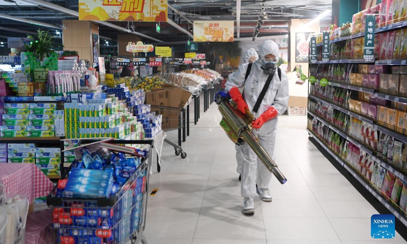 Staff members disinfect a shopping center in Chengguan District of Lanzhou, northwest China's Gansu Province, Oct. 19, 2021. Local authorities have strengthened the prevention and control measures to halt the spread of the coronavirus in the recent COVID-19 resurgence.(Photo:Xinhua)
