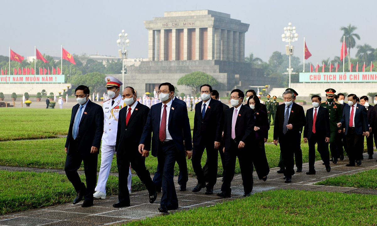 Vietnam's President Nguyen Xuan Phuc (center) and Prime Minister Pham Minh Chinh (left) attend a wreath laying ceremony at the mausoleum of Vietnam's late president Ho Chi Minh in Hanoi, Vietnam on Wednesday, ahead of the 15th National Assembly's second parliament session. Photo: AFP