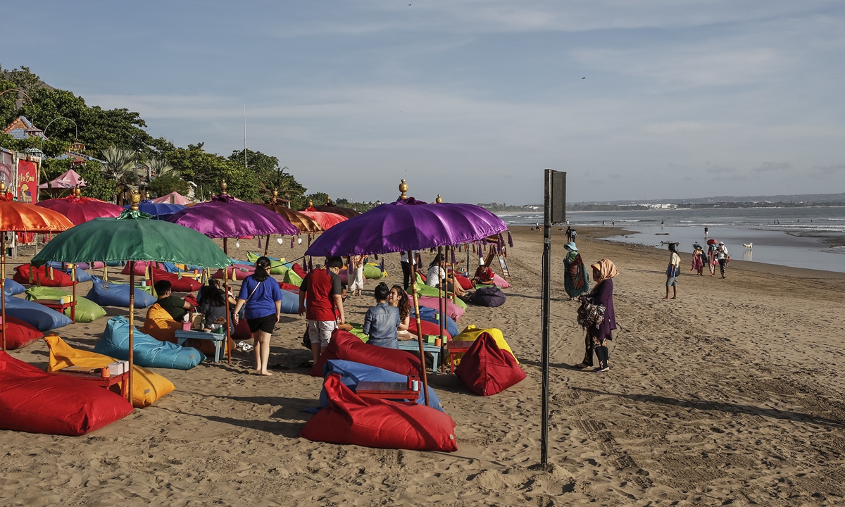 Visitors enjoy the beach during the government-relaxed COVID-19 restrictions in Seminyak, Bali, Indonesia on September 15. Photo: VCG