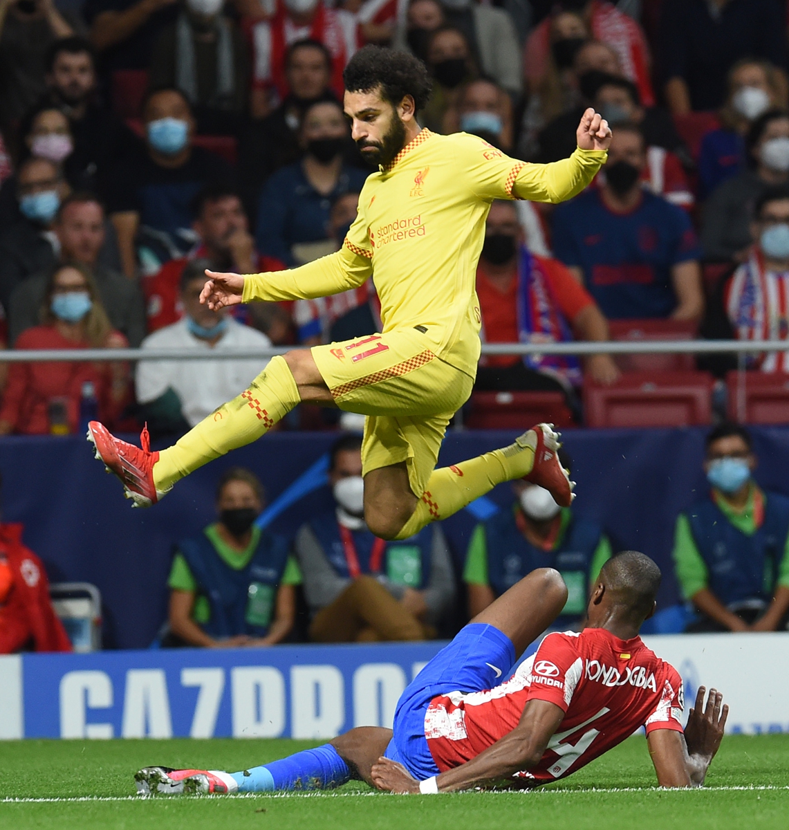 Mohamed Salah (above) of Liverpool evades a tackle from Geoffrey Kondogbia of Atletico Madrid on October 19 in Madrid, Spain. Photo: VCG