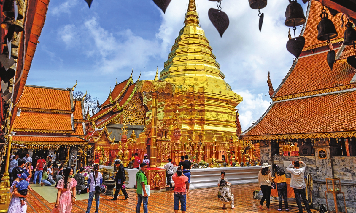Visitors take pictures of the gold-plated stupa at Wat Phra That Doi Suthep Buddhist temple in Chiang Mai, Thailand  in November 2020. Photo: AFP