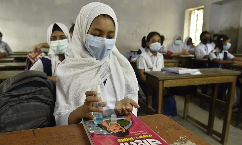 A student disinfects her hand at a school in Dhaka, Bangladesh, Sept. 14, 2021.(Photo: Xinhua)