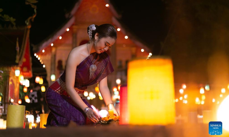 People take photos with lanterns in a temple at the end of the Buddhist Lent in Lao capital Vientiane, Oct. 21, 2021.Photo:Xinhua