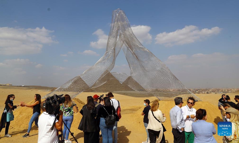 Visitors gather in front of Italian artist Lorenzo Quinn's sculpture Together during an international art exhibition in Giza, Egypt, on Oct. 21, 2021.Photo:Xinhua