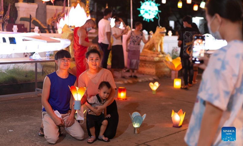 People take photos with lanterns in a temple at the end of the Buddhist Lent in Lao capital Vientiane, Oct. 21, 2021.Photo:Xinhua