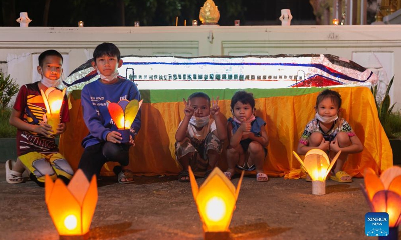 Children pose with lanterns in a temple at the end of the Buddhist Lent in Lao capital Vientiane, Oct. 21, 2021.Photo:Xinhua