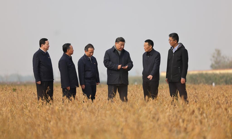 Chinese President Xi Jinping, also general secretary of the Communist Party of China Central Committee and chairman of the Central Military Commission, checks the growth of soybeans while visiting the Agricultural High-tech Industrial Demonstration Area of the Yellow River Delta in the city of Dongying, east China's Shandong Province, Oct 21, 2021. After the visit, Xi on Friday chaired a symposium on ecological protection and high-quality development of the Yellow River basin in Jinan, east China's Shandong Province.Photo:Xinhua