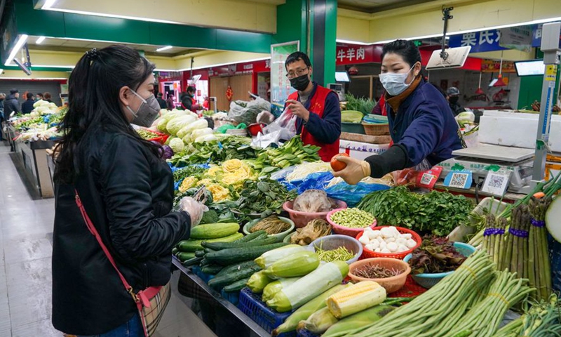 Citizens buy vegetables at a market in Nanjing, east China's Jiangsu Province.Photo:Xinhua