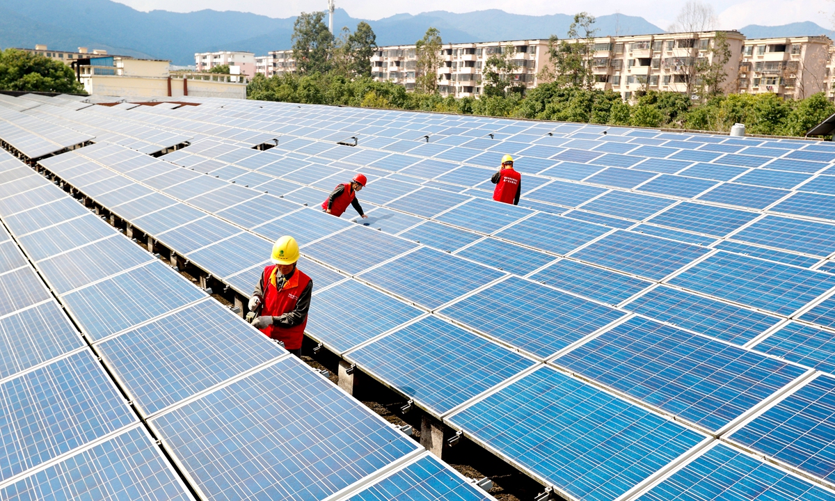 Workers install solar panels on the roof of an industrial building in Xiajiang county, East China's Jiangxi Province on October 25, 2021. The distributed solar power plant can generate electricity for industrial use or sell surplus power to the grid. Photo: VCG