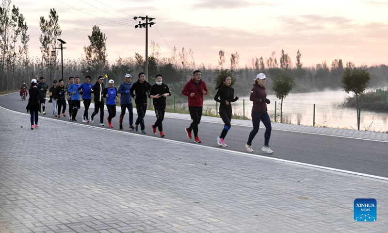 Citizens jog in the Grand Canal landscape belt of Botou City, north China's Hebei Province, Oct. 23, 2021. In recent years, Botou city has focused on restoring the natural ecology of the Grand Canal and creating a beautiful and comfortable leisure space for the public.  (Photo:Xinhua)