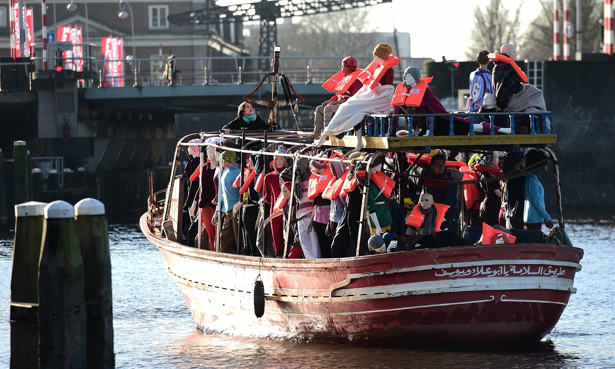 Amnesty International activists hold a protest against the ongoing migrant crisis with a boat filled with mannequins wearing life vests outside the Maritime Museum on January 25, 2016 in Amsterdam, the Netherlands during an informal meeting of EU Justice and Home Affairs ministers at the Maritime Museum. Photo: AFP