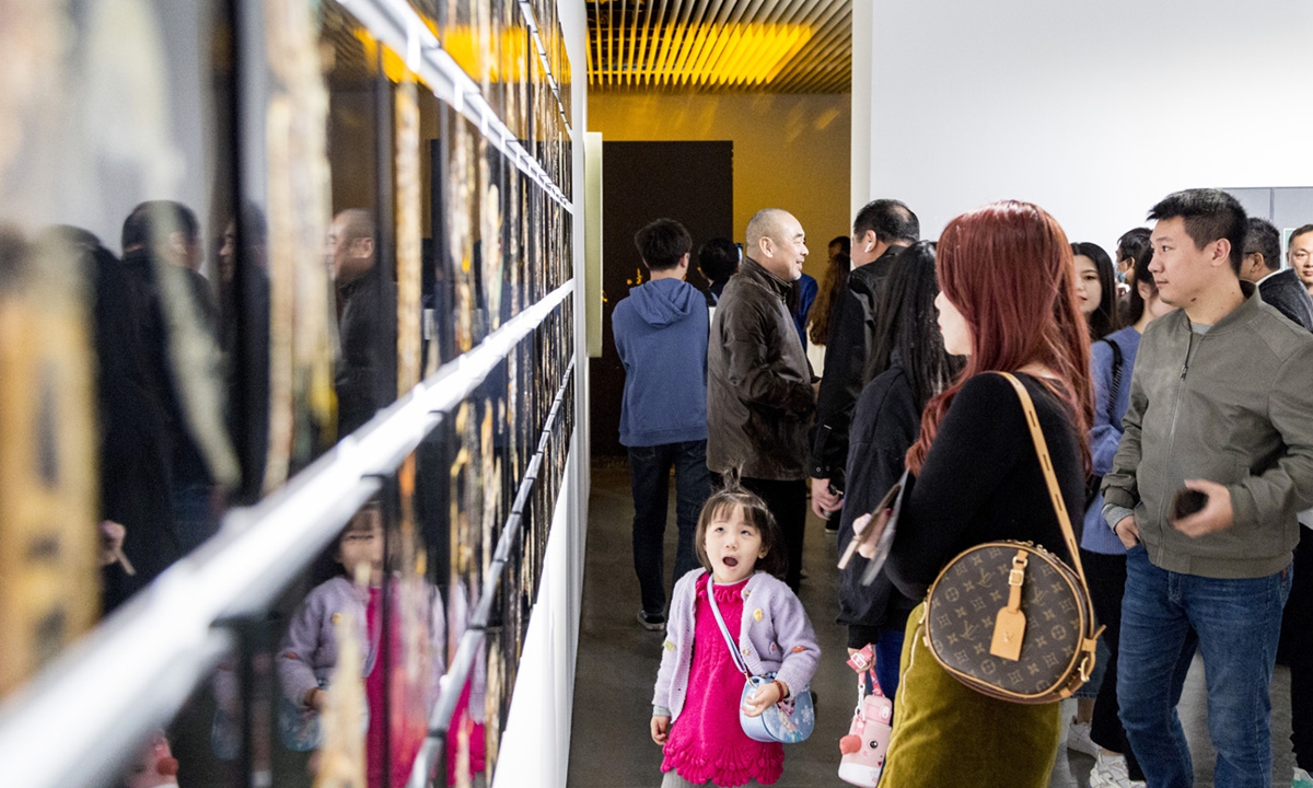 Vistors check the art pieces at the exhibition Photo: Courtesy of Zhang Guisen