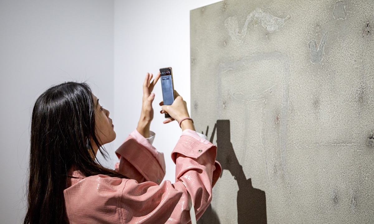 Vistors check the art pieces at the exhibition Photo: Courtesy of Zhang Guisen