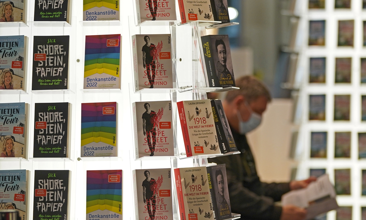 A visitor browses books at the Frankfurt Book Fair in Frankfurt, Germany on Wednesday. Photo: IC