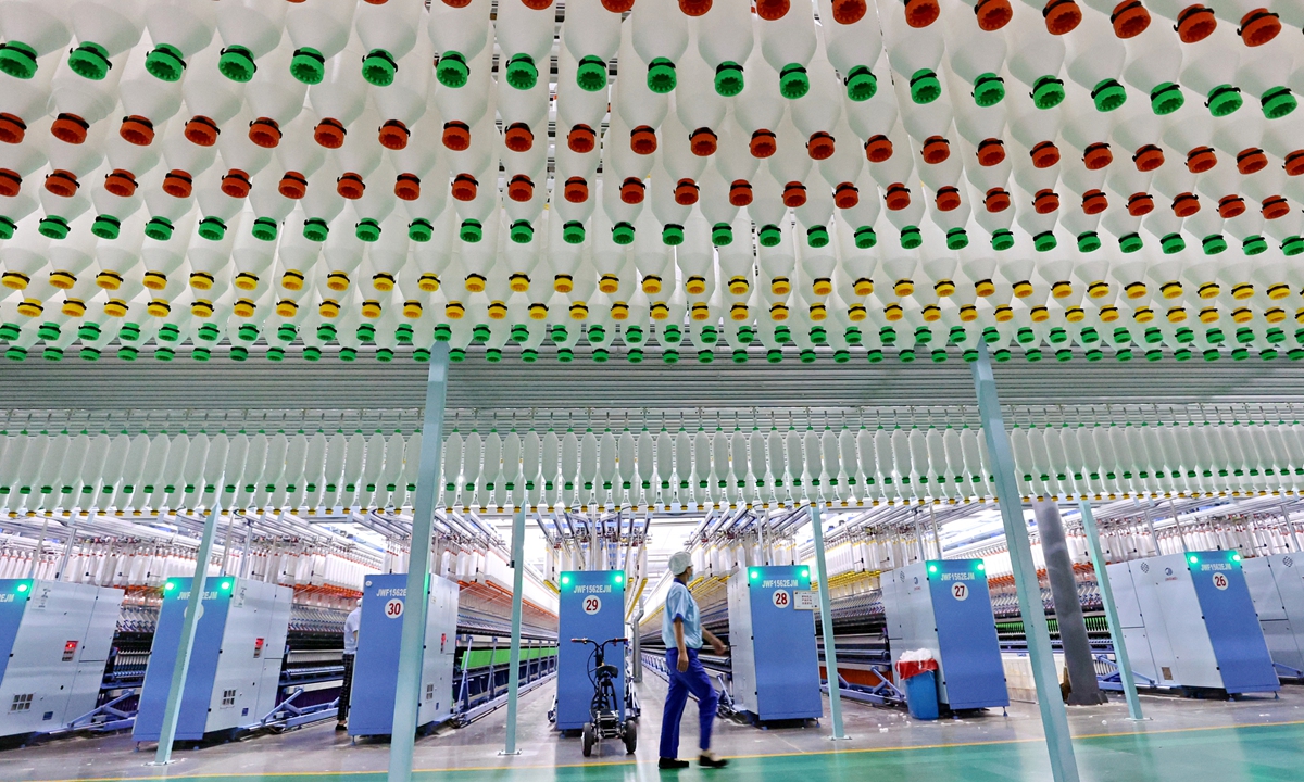 A worker walks in a digital spinning factory in Nantong, East China's Jiangsu Province on October 26, 2021. Thanks to digitalization, the textile company reported growth of more than 20 percent year-on-year in output value and sales in the first three quarters. Photo: cnsphoto