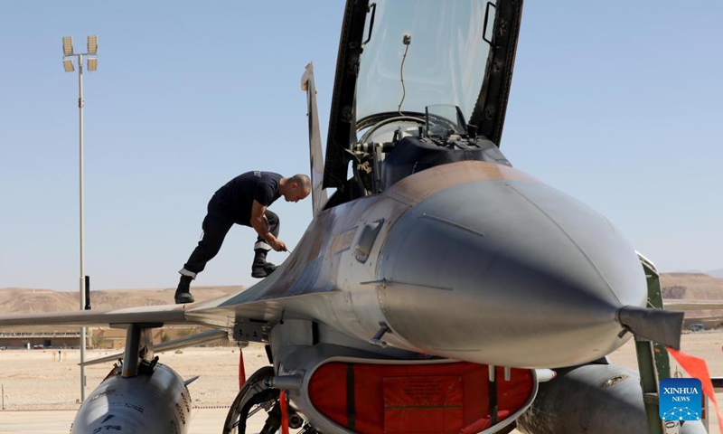 An Israeli technician checks a fighter jet during the international Blue Flag air combat exercise at the Ovda Air Force Base near south Israeli city of Eilat, Oct. 24, 2021. Air forces of eight countries began the international Blue Flag air combat exercise in Israel on Oct. 17.(Photo: Xinhua)