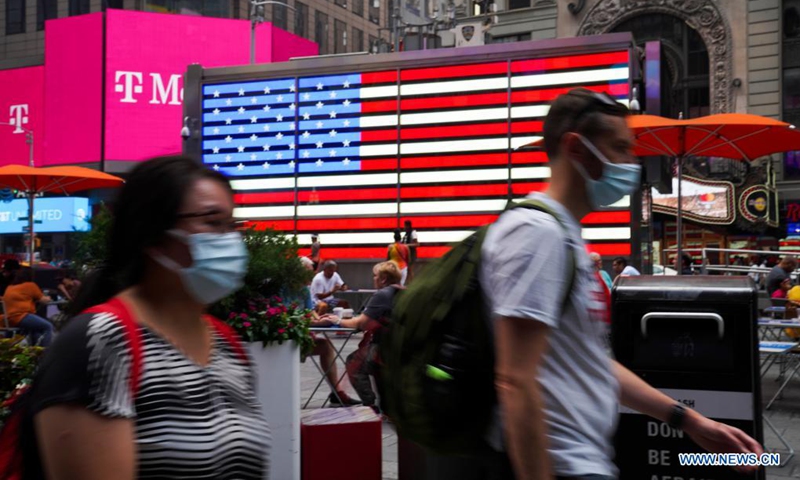 People wearing face masks walk in Times Square, New York, the United States, on July 20, 2021. Photo: Xinhua
