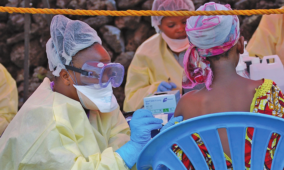 A girl receives a vaccine against Ebola from a nurse in Goma,the Democratic Republic of the Congo on August 7, 2019. Photo: AFP