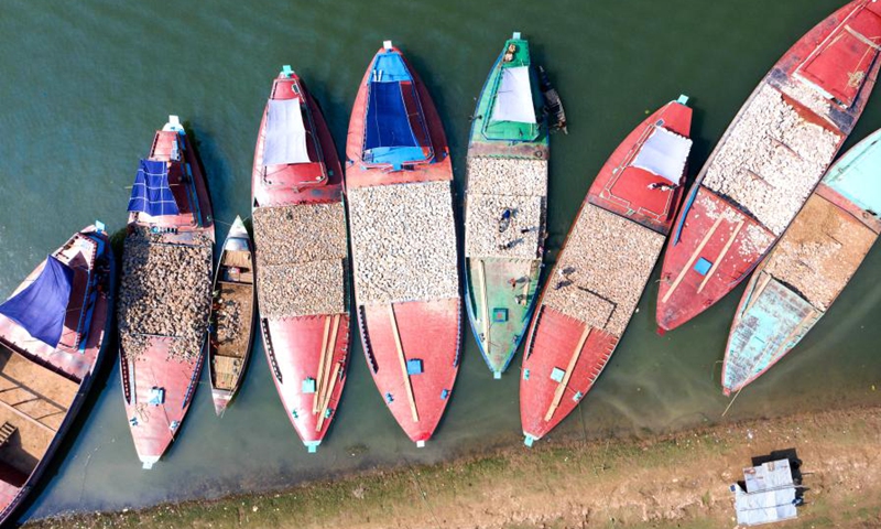 Aerial photo taken on Oct. 24, 2021 shows a view of boats loaded with stones on the Jadukata river in Sunamganj, Bangladesh.(Photo: Xinhua)