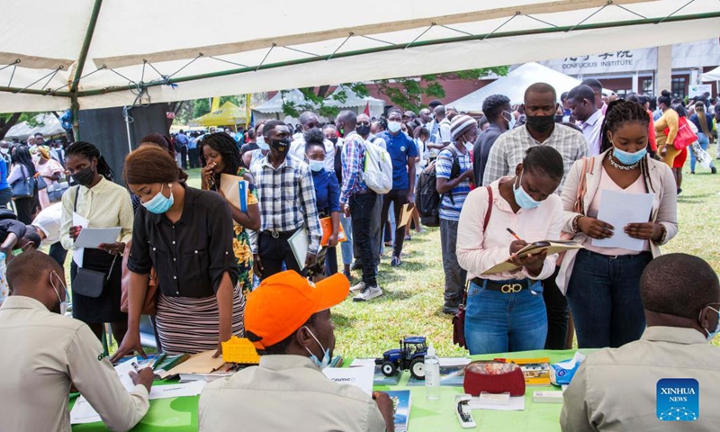 People attend a jobs and career expo at the University of Zambia in Lusaka, Zambia, on Oct. 27, 2021. The Confucius Institute at the University of Zambia (UNZA) on Wednesday held the fourth jobs and career expo where Chinese enterprises based in the southern African nation showcased themselves and tried to lure the local workforce, especially graduating students.(Photo: Xinhua)