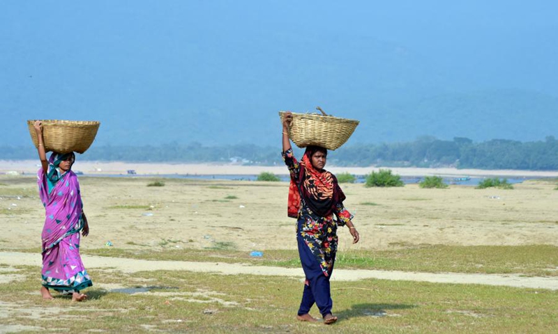 Two women work at a stone quarry on the bank of the Jadukata river in Sunamganj, Bangladesh, Oct. 24, 2021.(Photo: Xinhua)