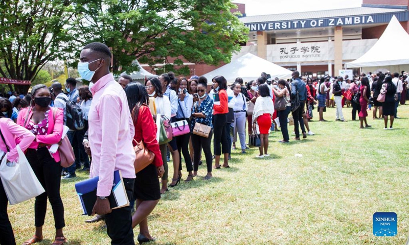 People attend a jobs and career expo at the University of Zambia in Lusaka, Zambia, on Oct. 27, 2021. The Confucius Institute at the University of Zambia (UNZA) on Wednesday held the fourth jobs and career expo where Chinese enterprises based in the southern African nation showcased themselves and tried to lure the local workforce, especially graduating students.(Photo: Xinhua)
