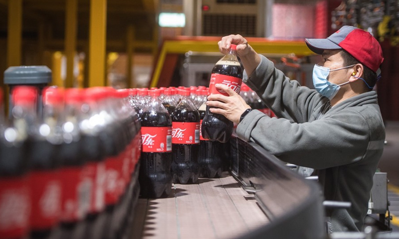 A man works at a production line of the Swire Coca-Cola Beverages Hubei Limited in Wuhan, central China's Hubei Province, March 24, 2020.Photo:Xinhua