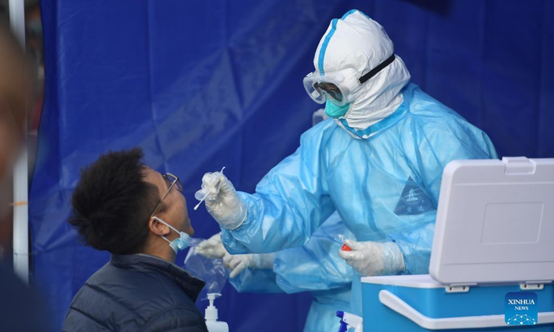 A medical worker takes a a swab sample from a citizen for nucleic acid testing in Xining, northwest China's Qinghai Province, Oct. 28, 2021. After Xining reported 3 new COVID-19 cases, local control of epidemic prevention has been strengthened.Photo:Xinhua