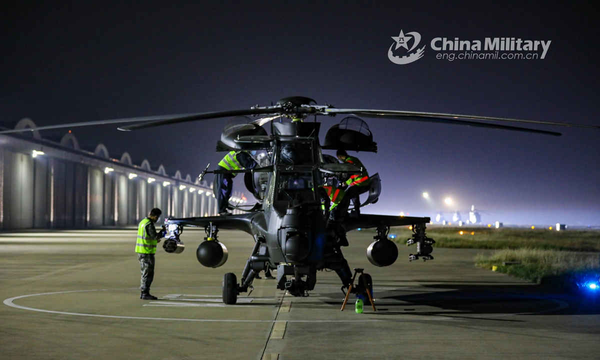 Maintenance men assigned to an army aviation brigade under the PLA 80th Group Army execute routine inspections on WZ-10 attack helicopters prior to a round-the-clock flight training exercise in mid October, 2021.Photo:China Military