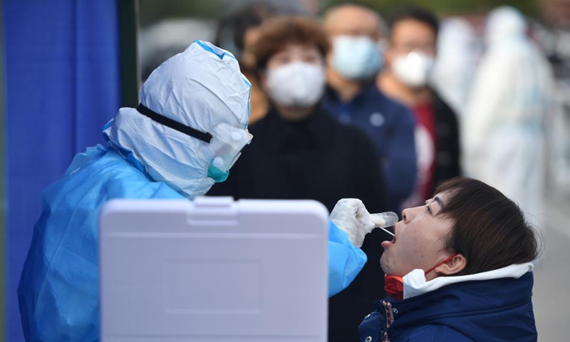 A medical worker takes a a swab sample from a citizen for nucleic acid testing in Xining, northwest China's Qinghai Province, Oct. 28, 2021.Photo:Xinhua