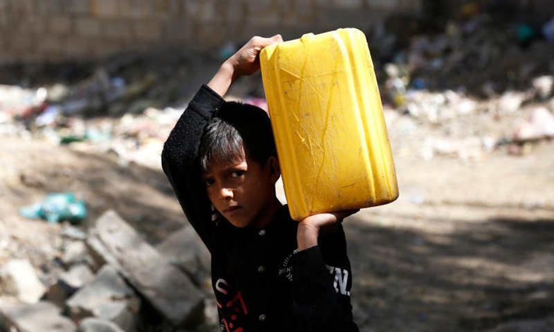 A Yemeni boy carries a plastic container near a charity water tap site in Sanaa, Yemen, on Oct. 28, 2021.Photo:Xinhua