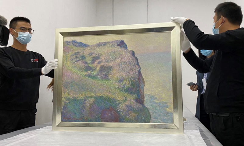 Working staff show an artwork by French impressionist painter Claude Monet at the Shanghai International Bonded Artwork Service Center on Friday. Photo: Yu Xi/Global Times

