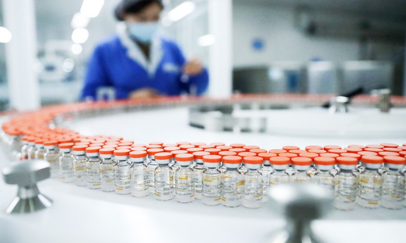 A staff member checks tags on vials of COVID-19 vaccine at a packing line of Sinovac Life Sciences Co., Ltd. in Beijing, capital of China, Dec 23, 2020.Photo:Xinhua