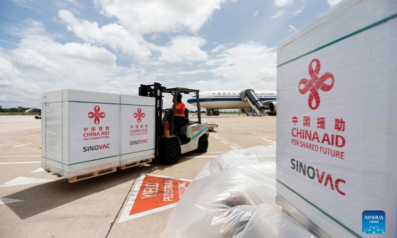 An airport worker transports packages of Sinovac COVID-19 vaccine at Phnom Penh International Airport in Phnom Penh, Cambodia, on Oct 14, 2021.Photo:Xinhua